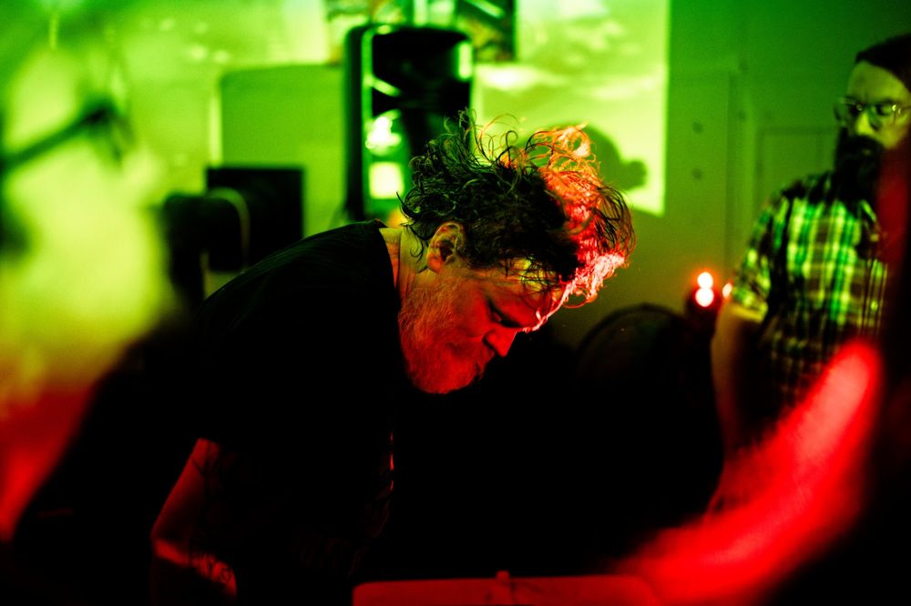 Press photo: Taxxess performing live under green and red light
